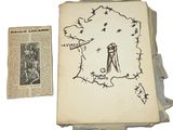 un vieux livre sur lequel figure un dessin, à côté d'une feuille de papier