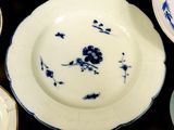 many plates and bowls that are on a table