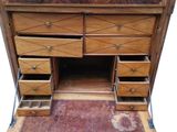 a wooden desk with drawers and a mirror on it