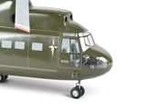a green model of a military helicopter on a white background