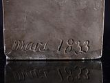 an image of a silver plate with writing on it
