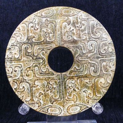 an image of a gold plate with designs on it on a black background