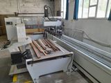 a machine that is working on a piece of wood