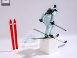 a figurine of a man on skis next to a computer