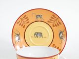 a cup and saucer with a picture of a giraffe on it