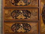 a wooden chest of drawers with a clock on it