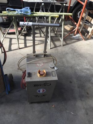 a machine that is sitting on the ground in a garage