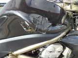 a close up of a motorcycle that is parked on the street