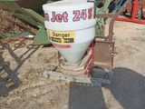 a white bucket sitting on the ground next to a green boat