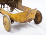 a yellow toy car that is sitting on a white surface