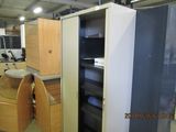 a tall cabinet with two doors open in a room