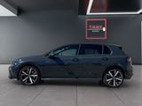 a blue volkswagen golf gt - line parked in a showroom