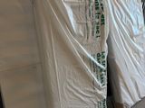 many boxes of mattresses in a warehouse with a tarp covering them