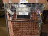 a cage with a television on top of it in a warehouse