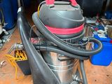 a vacuum that is sitting on the floor in the garage