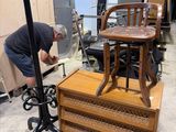 a man that is working on a chair in a room