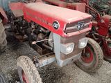 a red tractor that is parked in a garage