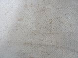 a close up picture of a dirty carpet with stains on it