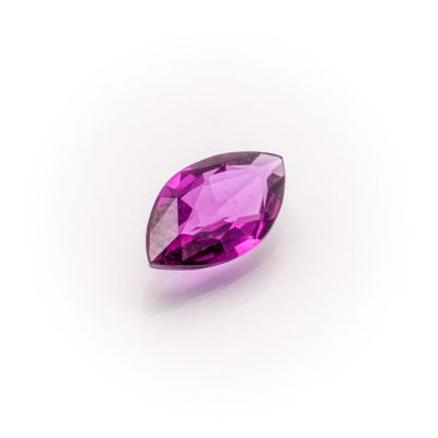 a close up of a purple gemstone on a white background