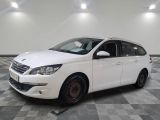 la voiture blanche est garée sur un sol en damier dans le garage