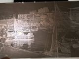 a black and white photo of a boat in a harbor