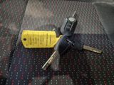 a car key and a remote control on the seat of a car