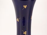 a blue vase with gold flowers on it on a white background