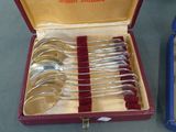 silverware in a red case with a red handle and spoons in it
