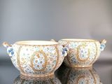 two bowls sitting on a table next to each other
