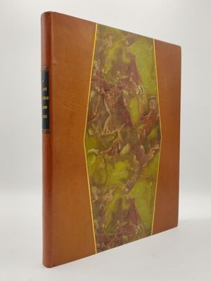 un vieux livre avec une couverture marron et une couverture verte et jaune