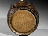 a close up of a wooden vase on a table