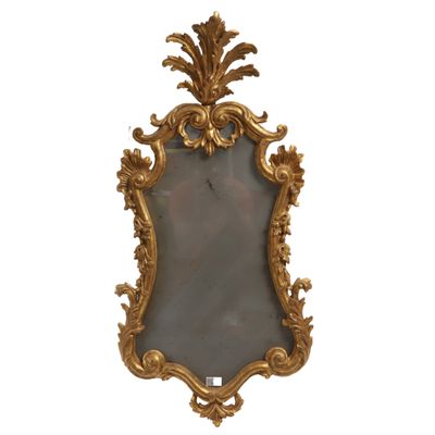 an image of a gold framed mirror on a white wall