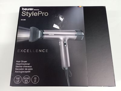 the box of a blow dryer sitting on top of a white table