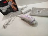 a white and purple electric hair dryer on a table