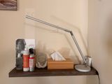 a lamp that is on a shelf in the corner of a room