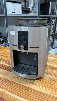 a coffee maker sitting on a wooden table in a kitchen