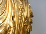 a gold statue of a man with a hat on his head