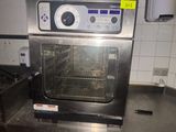 an oven that is sitting in a kitchen next to a stove