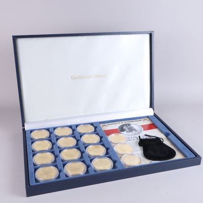a blue box with twelve gold coins in it