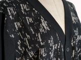 a close up of a black and white sweater on a mannequin mannequin