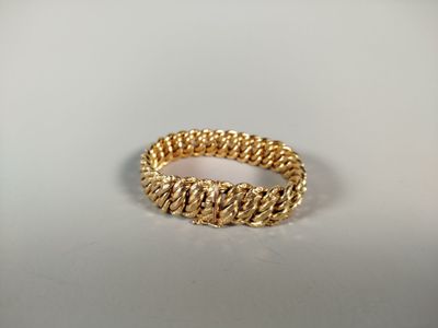 a close up of a gold ring on a white surface
