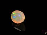 a white fire oplite stone on a black surface