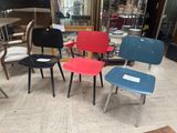 four chairs that are sitting in the middle of a room