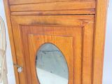 a small wooden cabinet with a mirror in it