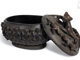 a small bowl with a lid that has a design on it