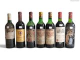 a group of six bottles of wine sitting next to each other