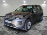 the grey land rover is parked in a large room with a checkered floor