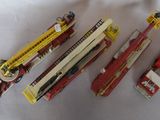 several toy fire trucks are lined up on a white surface