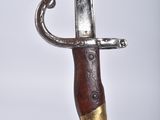 a close up of a knife on a white surface
