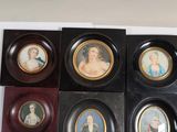 four framed miniature portraits of women and children in black frames